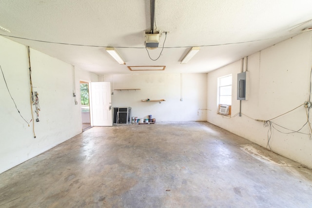 garage featuring a garage door opener and electric panel