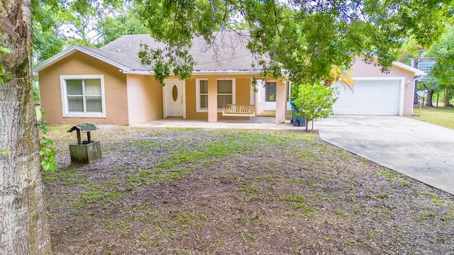 single story home with covered porch and a garage