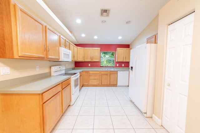 kitchen with light tile patterned floors, white appliances, sink, and lofted ceiling