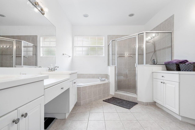 bathroom featuring tile patterned floors, vanity, and shower with separate bathtub