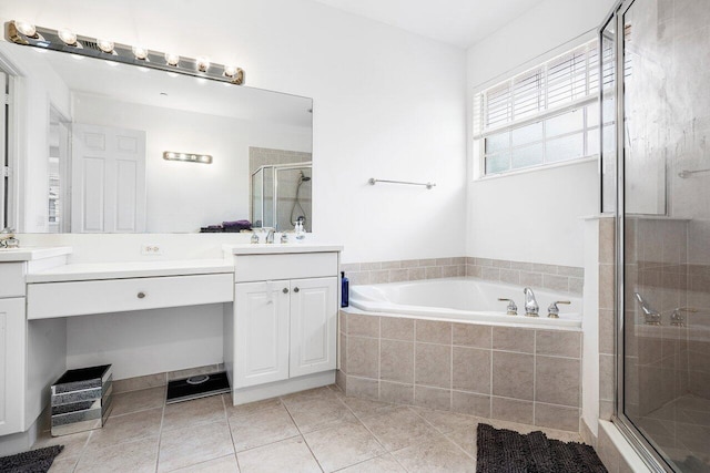 bathroom featuring tile patterned floors, vanity, and shower with separate bathtub