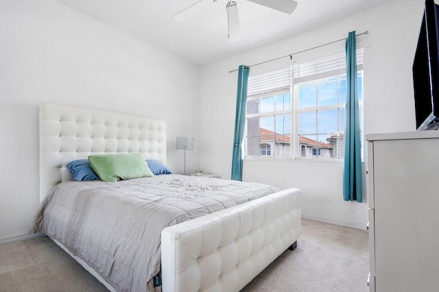 bedroom with ceiling fan and light carpet