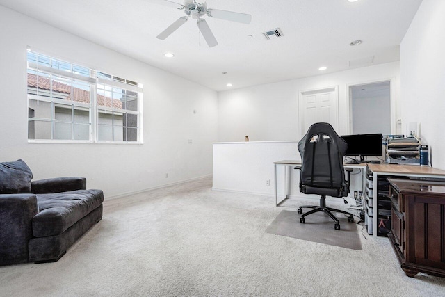 office space featuring light carpet and ceiling fan