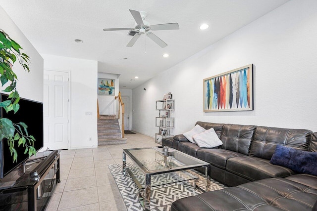 living room with light tile patterned floors, a textured ceiling, and ceiling fan