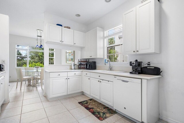 kitchen featuring dishwasher, plenty of natural light, white cabinetry, and sink