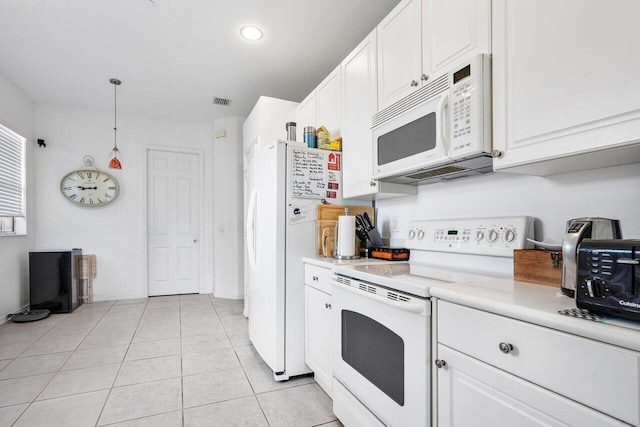 kitchen featuring white cabinets, pendant lighting, white appliances, and light tile patterned flooring