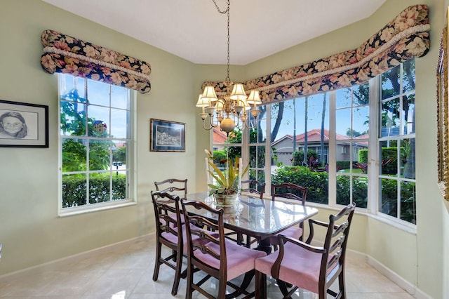 dining area featuring an inviting chandelier and light tile patterned floors