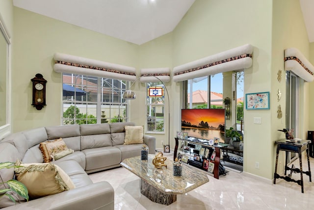 tiled living room with high vaulted ceiling