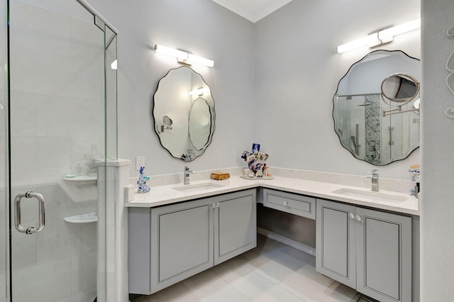 bathroom featuring tile patterned flooring, an enclosed shower, and vanity