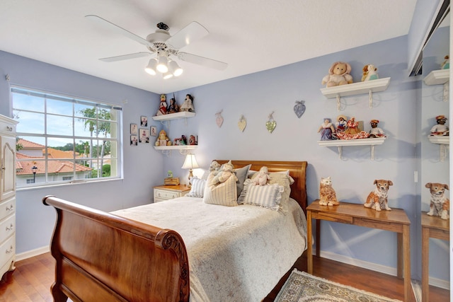 bedroom with ceiling fan and wood-type flooring