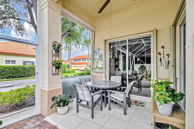 sunroom / solarium featuring ceiling fan