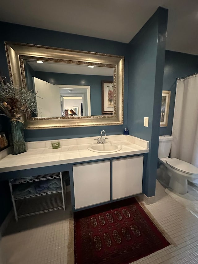 bathroom with vanity, tile patterned flooring, and toilet