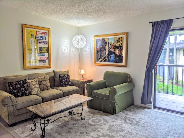 living room with a textured ceiling, carpet, an inviting chandelier, and a wealth of natural light