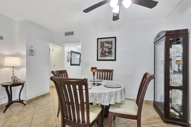 tiled dining room featuring ceiling fan