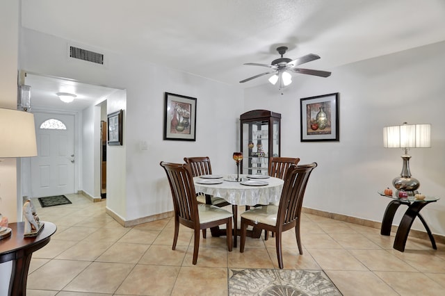 tiled dining area featuring ceiling fan