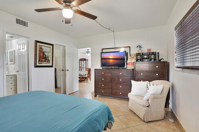 tiled bedroom with ceiling fan and ensuite bathroom