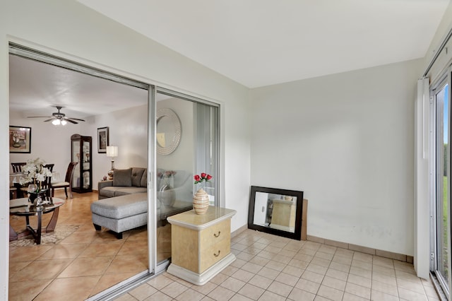 living room with ceiling fan and light tile patterned flooring