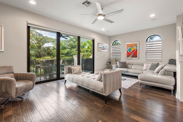 living room featuring ceiling fan and hardwood / wood-style flooring