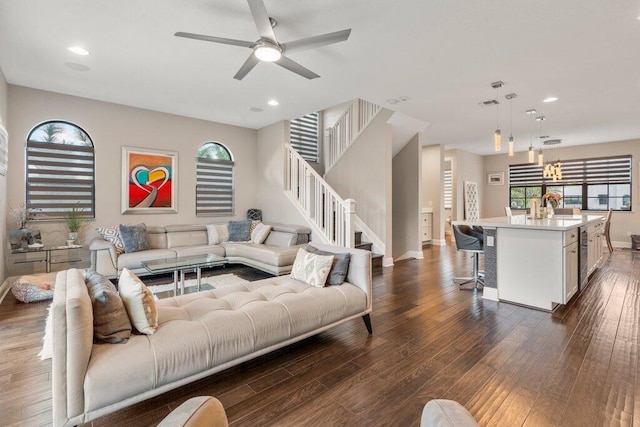 living room with ceiling fan and dark hardwood / wood-style flooring