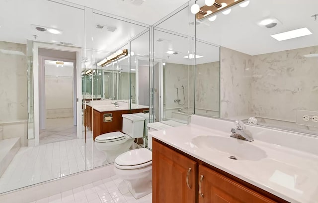 bathroom with tile patterned flooring, vanity, toilet, and a shower with shower door