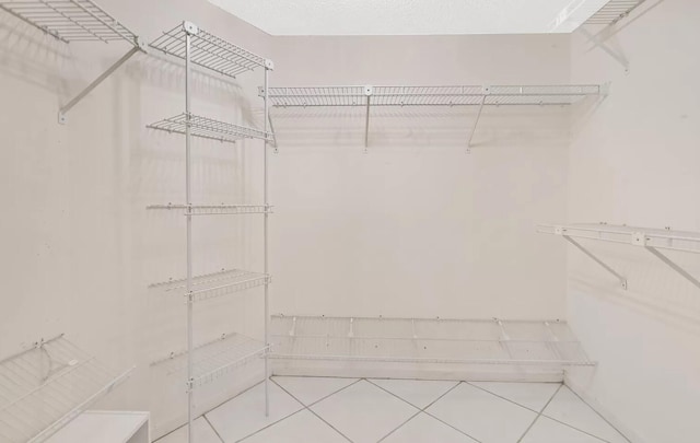 spacious closet featuring tile patterned floors