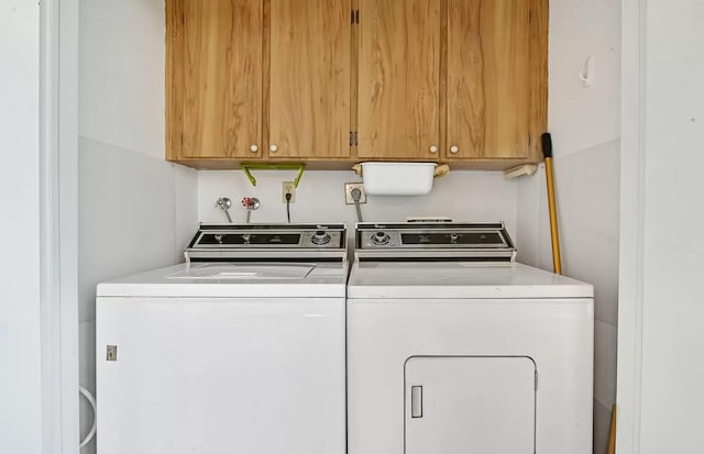 laundry area featuring cabinets and independent washer and dryer