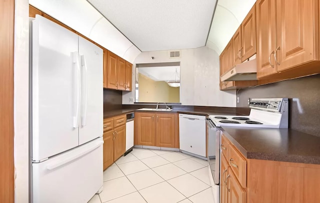 kitchen with light tile patterned floors, white appliances, a textured ceiling, and sink