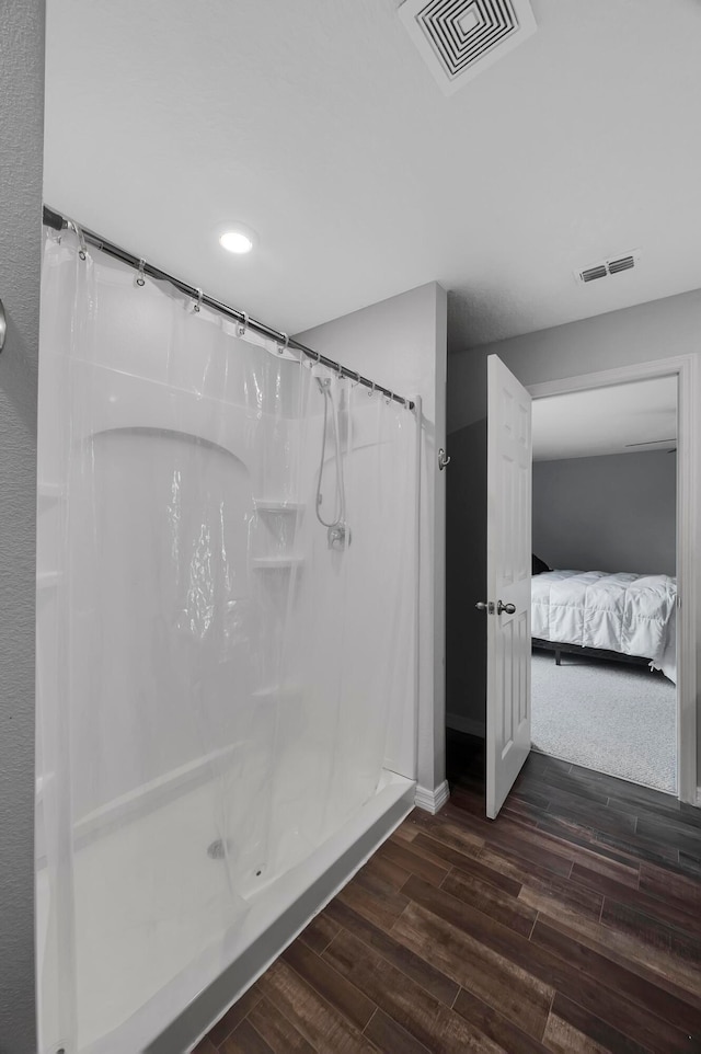 bathroom with hardwood / wood-style floors and a shower with shower curtain