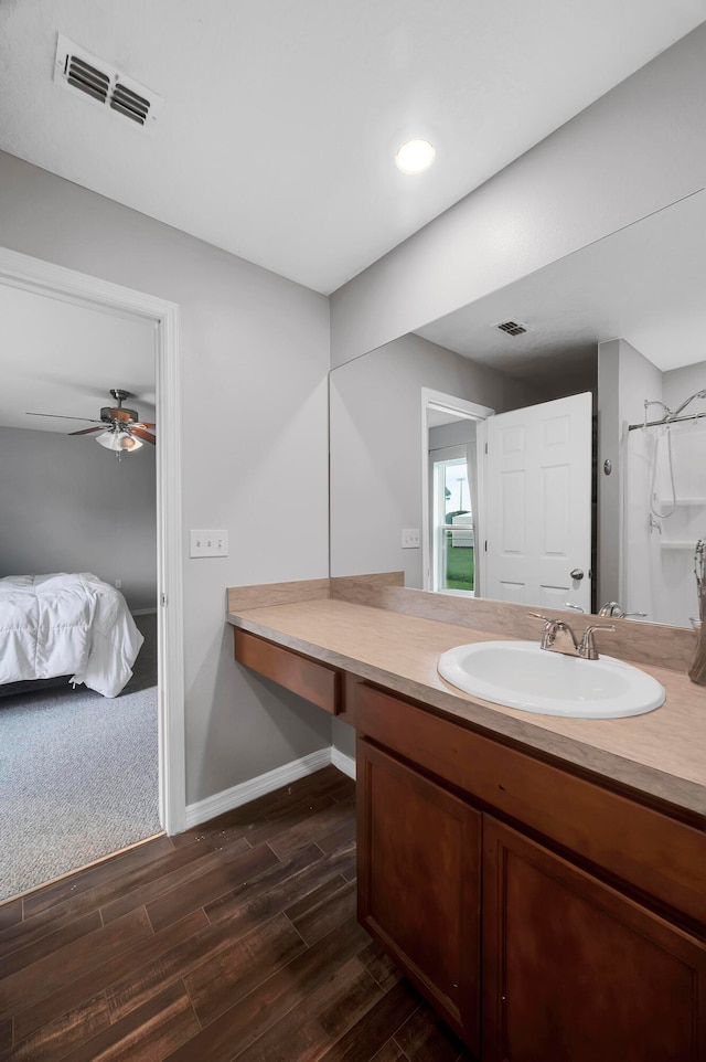 bathroom with vanity, ceiling fan, hardwood / wood-style flooring, and a shower