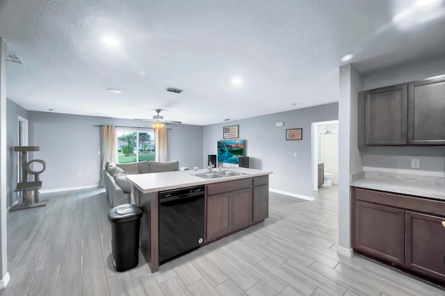 kitchen with dishwasher, a kitchen island with sink, sink, dark brown cabinetry, and light hardwood / wood-style floors