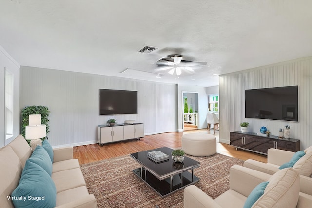 living room featuring hardwood / wood-style flooring and ceiling fan