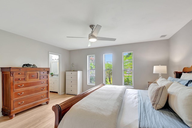 bedroom with connected bathroom, light hardwood / wood-style floors, and ceiling fan