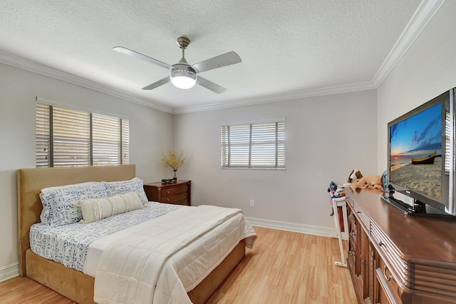 bedroom with multiple windows, crown molding, a textured ceiling, and light wood-type flooring