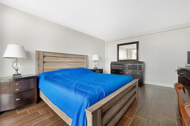 bedroom featuring wood finish floors and baseboards