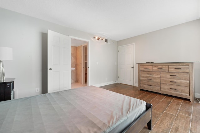 bedroom with visible vents, baseboards, and dark wood-style flooring