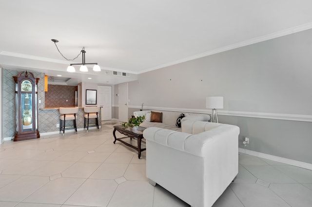 living room with visible vents, an accent wall, baseboards, and ornamental molding