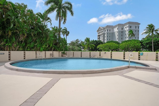 pool featuring a patio and fence