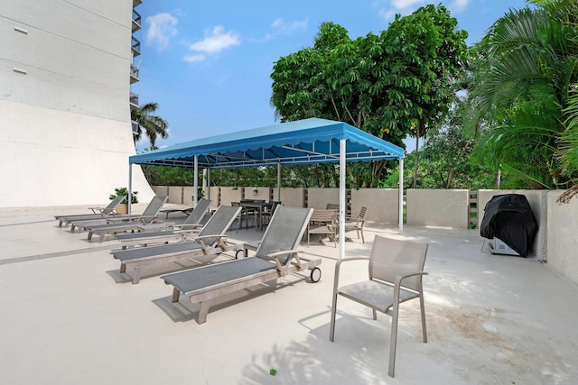 view of patio with a gazebo and fence