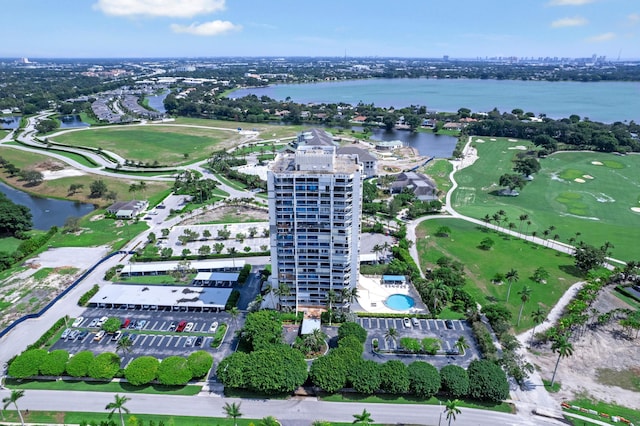 aerial view with golf course view and a water view