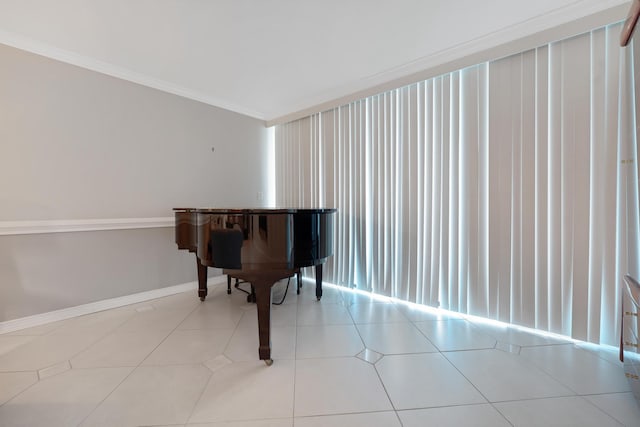 sitting room with tile patterned floors, crown molding, and baseboards