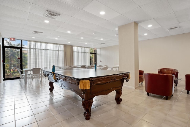 rec room with light tile patterned floors, visible vents, and floor to ceiling windows