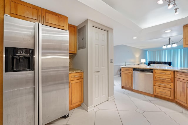 kitchen featuring light stone counters, baseboards, appliances with stainless steel finishes, and light tile patterned flooring