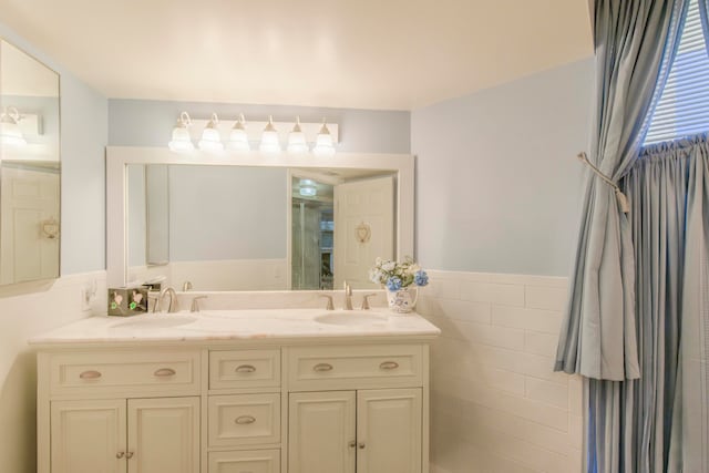 bathroom featuring vanity and tile walls