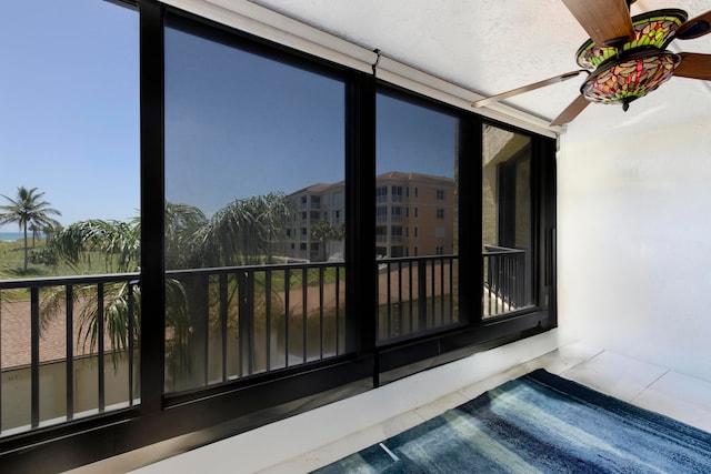 sunroom featuring ceiling fan