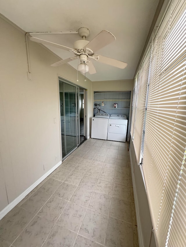 interior space featuring ceiling fan, light tile patterned flooring, and washing machine and dryer