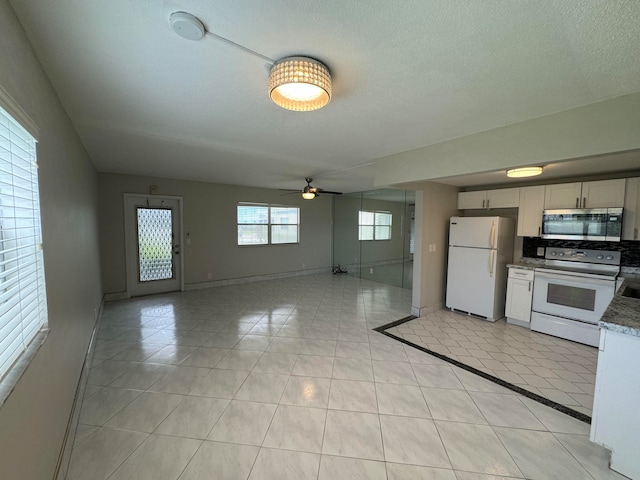 kitchen featuring ceiling fan, backsplash, white appliances, and light tile patterned floors