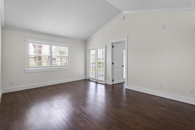 spare room featuring lofted ceiling, crown molding, a textured ceiling, and dark wood-type flooring