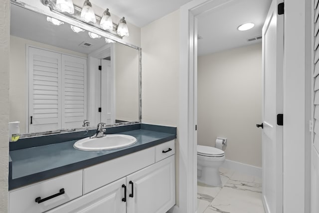 bathroom featuring visible vents, baseboards, toilet, marble finish floor, and a closet