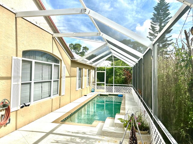 view of pool with a patio and a lanai