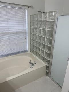 bathroom with tile patterned floors and separate shower and tub